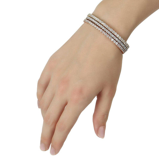 Close-up of a wrist wearing a Rosy Elegance round diamond bangle in 14K rose gold with 8 carats of E/VS1 brilliant round diamonds